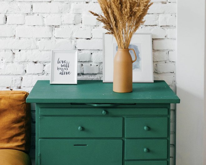 Image of drawers with a vase and flowers ontop of it